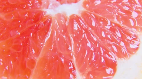 Red citrus fruit slices of grapefruit on rotating surface Stock Footage 172840643