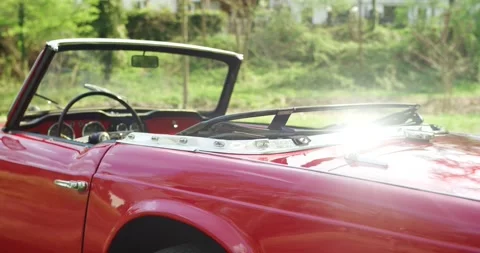 Red Classic Convertible Side Profile, Chrome Trim, Green Landscape Backdrop Stock Footage 340646670