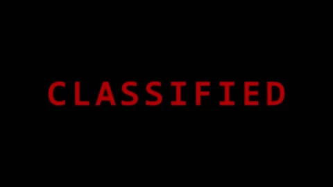 Red CLASSIFIED text appearing on black background with cinematic motion and.. Video stock 343478847