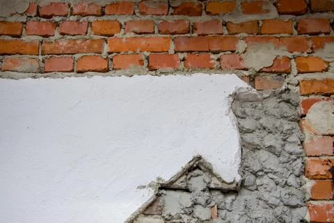 The red clay brick wall is covered with cement and plaster. Facing work Stockfoto's