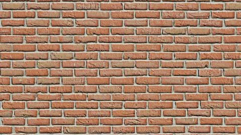 Red clay brick wall surface texture as background image, old tiles, masonry. Stock Photos