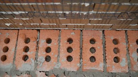 Red clay bricks and blocks for building and construction, close-up. Brickwork Stockfoto's