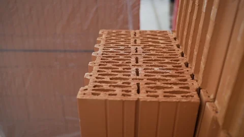 Red clay bricks are stacked on wooden pallets. Stock Footage 119934051