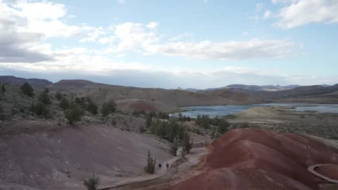 Red clay hills and trail at the Painted Hills in Central Oregon Stock Footage 346794697
