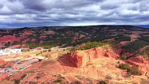 Red clay rock formations and industrial area landscape Video stock 330492153