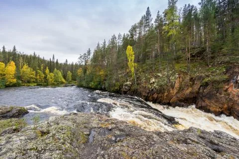 Red cliff, stone wall, forest, waterfall and wild river view in autumn. Fall  Stock Photos