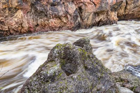 Red cliff, stone wall, forest, waterfall and wild river view in autumn. Fall  Stock Photos