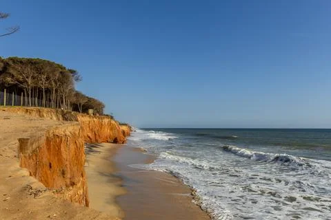 Red Cliffs and Atlantic Ocean Coastline in Quarteira Algarve Portugal Stock Photos