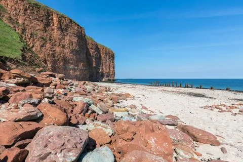 Red cliffs and beach at German island Helgoland Stock Photos