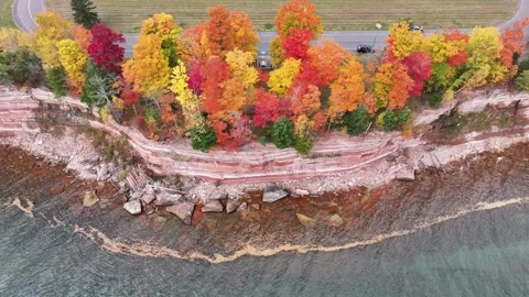 Red Cliffs and Vibrant Autumn Colors Aerial on Beautiful Blue Lake Superior Stock Footage 315265663