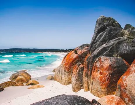 Red Cliffs on a Blue Beach Stock Photos