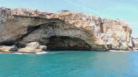 Red Cliffs With Cave Seen From The Sea Stock Footage 49882318