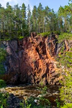 Red cliffs, pine forest and river in Oulanka national park in northern Finland Stock Photos