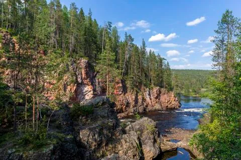 Red cliffs, pine forest and river in Oulanka national park in northern Finland Stock Photos