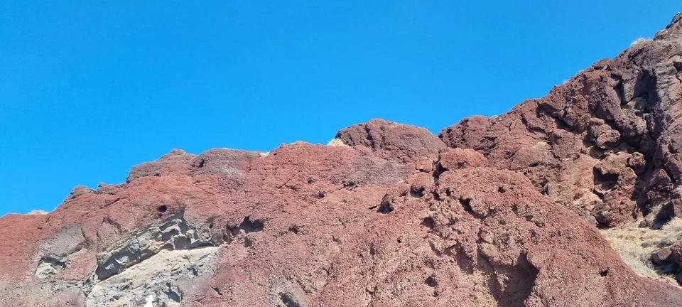 Red cliffs on the red beach santorini greece Stock Photos