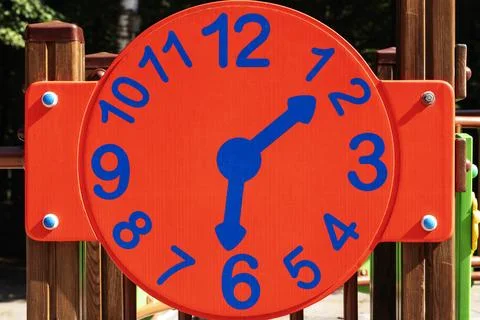 Red clock, Clock on the playground.   concept Kids time Stock Photos