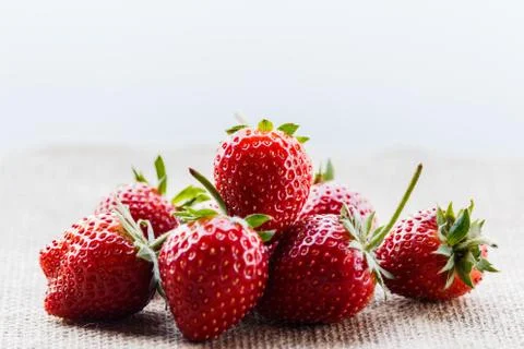 Red close up strawberries with selective focus on a strawberry with many st.. Stock Photos