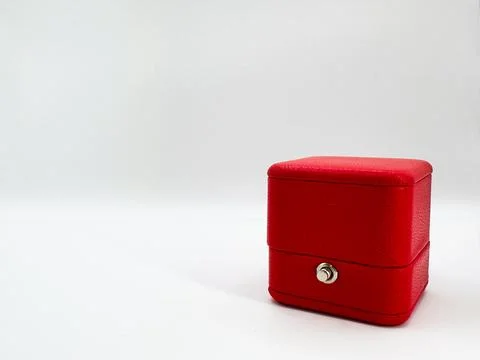 Red closed rectangular leather wedding ring box on white background right s.. Stock Photos