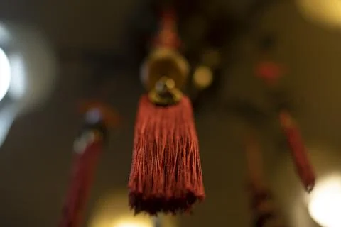Red cloth hanging from ceiling. Thread brush. Interior decoration. Indian D.. Stock Photos