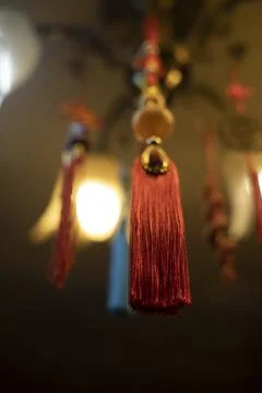 Red cloth hanging from ceiling. Thread brush. Interior decoration. Indian D.. Stock Photos