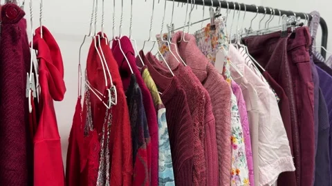 Red clothes in second hand store Stock Footage 264706655