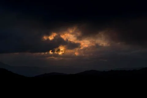 Red clouds in dark landscape Stock Photos