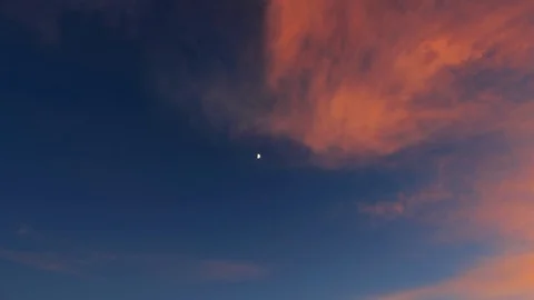 Red clouds in the evening sky with the moon Stock Footage 96027949