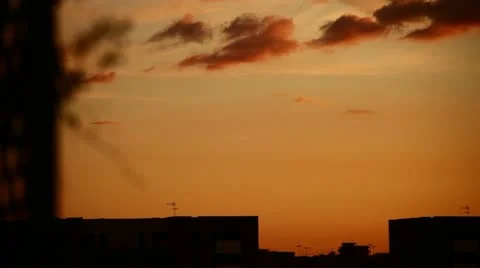 Red clouds in the sky with build on background Stock Footage 10893400