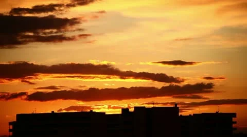 Red clouds in the sky with build on background (timelapse) Stock Footage 10893432