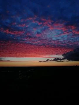 Red clouds in the sky at the sunset Stock Photos