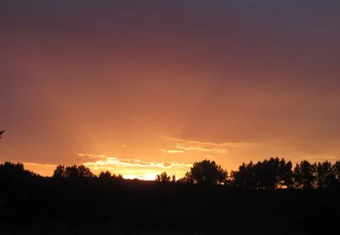 Red clouds at sunset, on a blue-gray sky background Stock Photos