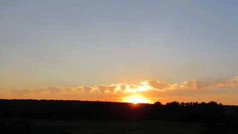 Red clouds at sunset, on a blue-gray sky background Stock Photos