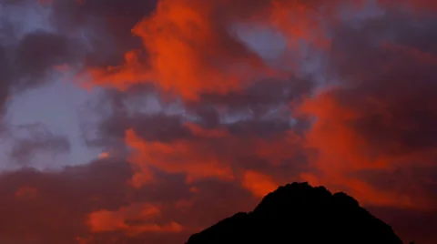 Red Clouds at Sunset Over a Distant Mountain Stock Footage 35154519