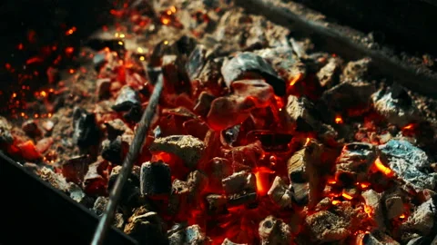 Red coals are being mixed by rake in grill station, close up. Video stock 86737682