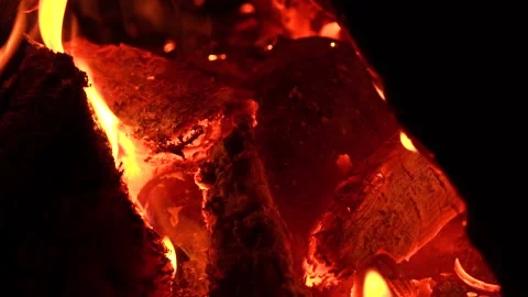 Red coals in the fire close-up. Close up. Red-orange coals flicker in the dark Stock Footage 141618549