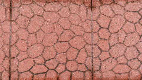 Red Cobblestone Patterned Road Pavement Surface with a Seam Line 写真素材