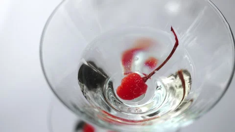 Red Cocktail Cherry in Clear Drink Glass Close Up. Stock Footage 345780998