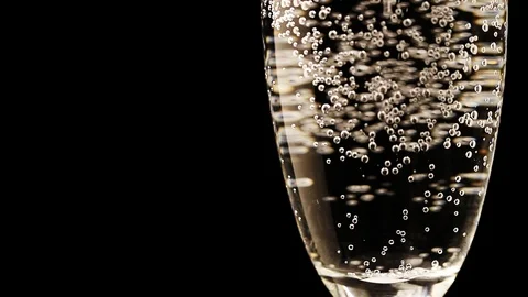 Red cocktail cherry falling in glass of champagne Stock Footage 100417515