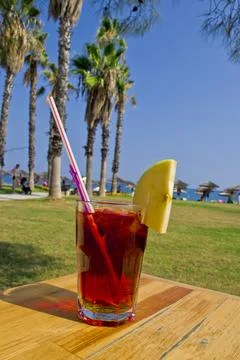 A red cocktail with fruit on the beach Stock Photos