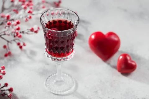 Red cocktail, vodka or liqueur and Heart shape decorations Stock Photos