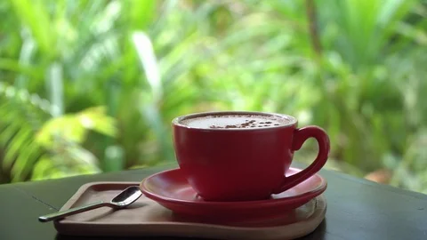 Red coffee cup on wood table Stock Footage 114753401