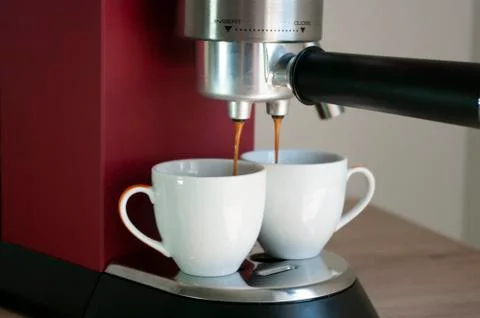 Red coffee machine and two cups, mockup, espresso make. Stock Photos