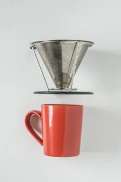 Red coffee mug on white background with filterless metal pour over drip cone Stock Photos