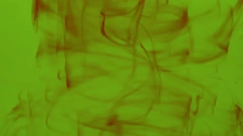 Red color drops are diffusing in green liquid. Stock Footage 201333237