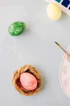 Red color easter egg on small nest over bright background Stock Photos