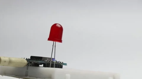 Red color LED blinking that is connected to breadboard Stock Footage 327978515