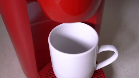 Red color machine serving black coffee in a cup Stock Footage 129172474