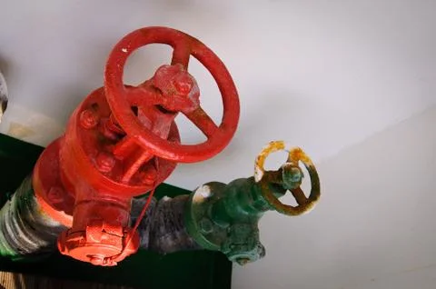 Red color ship valve and green ship valve. Metals, maritime, seaway concept Stock Photos