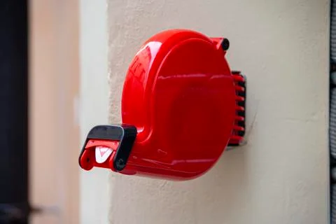 Red color shop queue eliminator fixed to the wall Stock Photos