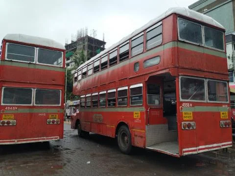Red colored Double-Decker buses moving on the road. Stock-Fotos